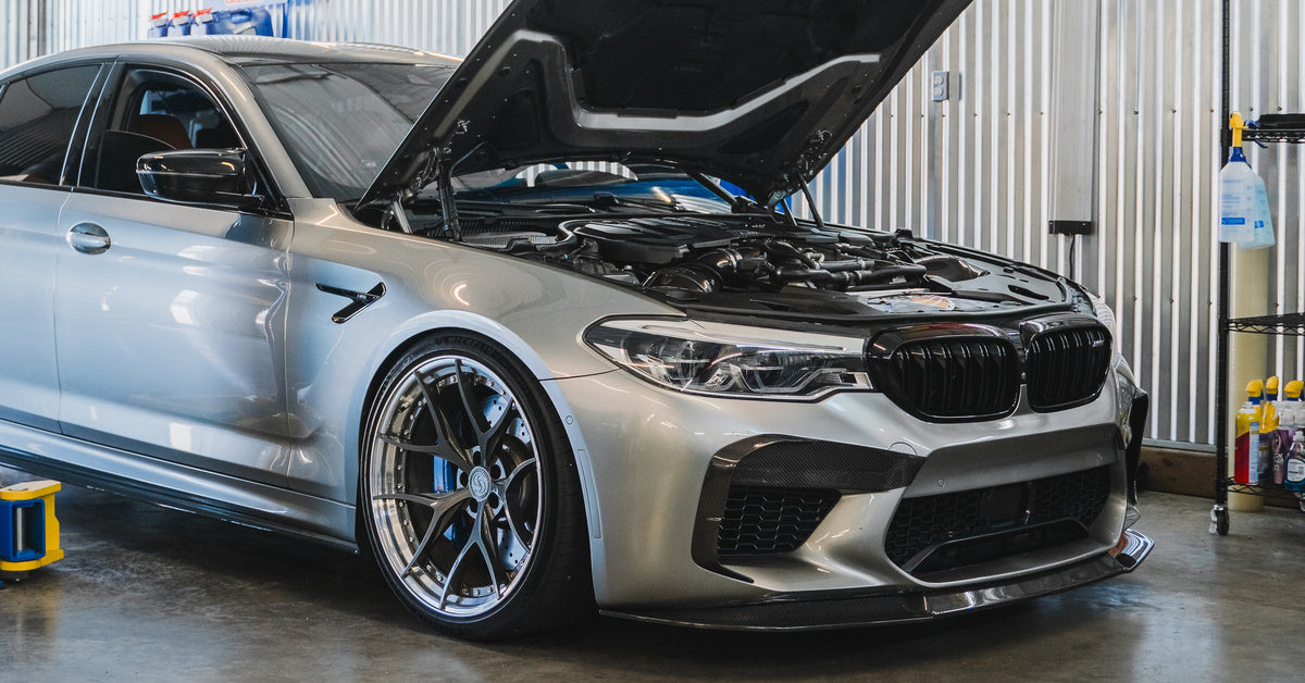 BMW M5 in the Werke Autosport workshop with its hood open
